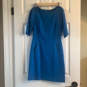 Fitted blue dress with *pockets*